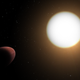 An orange, oval world orbits around its yellow-white host star in this illustration.